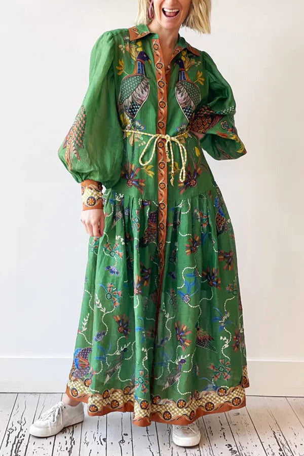 Green midi dress with bird print, flutter sleeves, and belted waist. Perfect for a casual day out or weekend getaway.