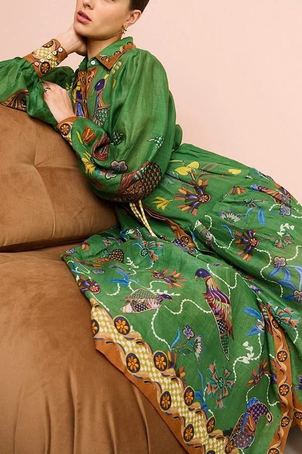 Green midi dress with bird print and sleeves made of soft cotton blend fabric. Perfect for casual outings and everyday wear.