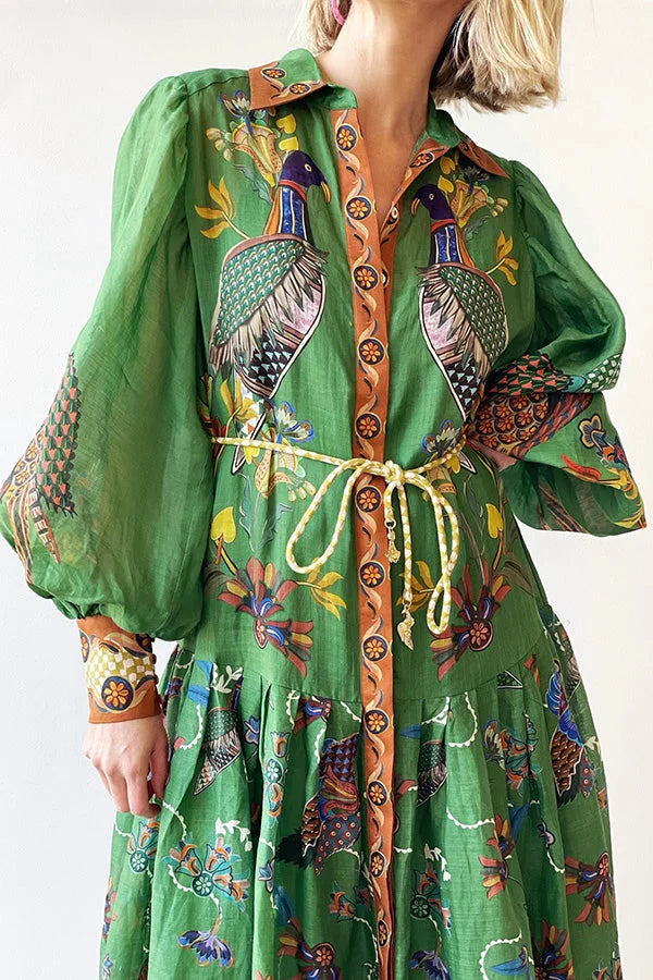 Green midi dress with bird print, featuring elegant sleeves. Made from lightweight, breathable fabric ideal for all-day…