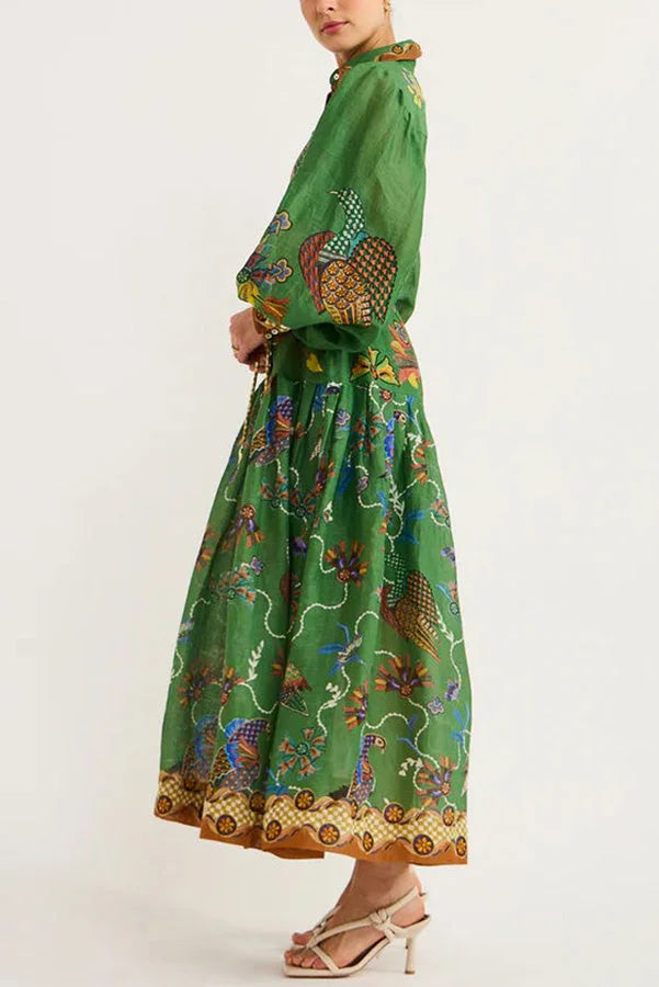 Green midi dress featuring a charming bird print, with stylish sleeves, in a soft and lightweight fabric.