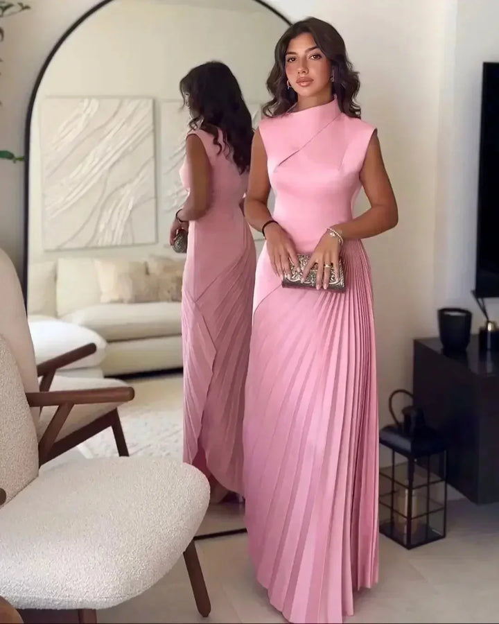 Pink pleated midi dress in a sleek design by Avalina, perfect for any occasion. Made of high-quality, flowy fabric for an…