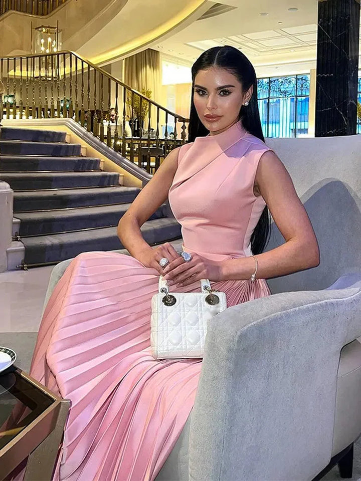 Pink pleated midi dress made from lightweight fabric, featuring a sleek design perfect for a chic and stylish look.