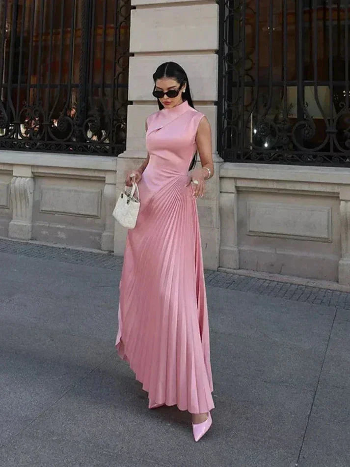 Pink pleated midi dress with a sleek design, made from soft and flowy material. Features a flattering silhouette and trendy…