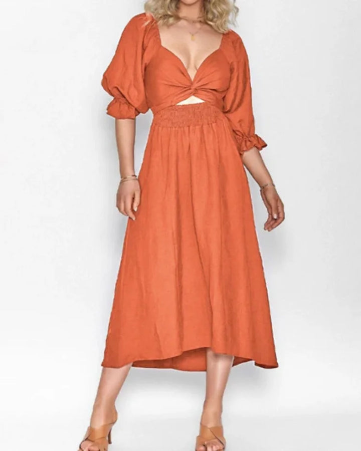 Orange wrap dress with deep V-neckline by Avelina. Flowy and comfortable jersey fabric perfect for casual or special…