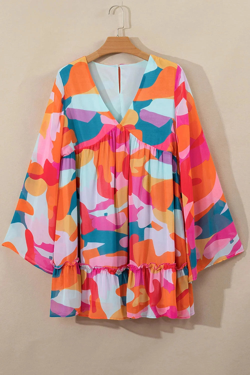 Colorful V-neck babydoll dress with a vibrant print pattern, made from soft and breathable fabric.