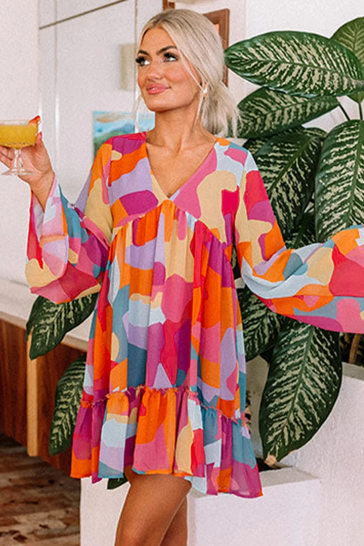 "Vibrant printed V-neck babydoll dress by Averee, featuring a flowy silhouette and colorful pattern, perfect for summer…