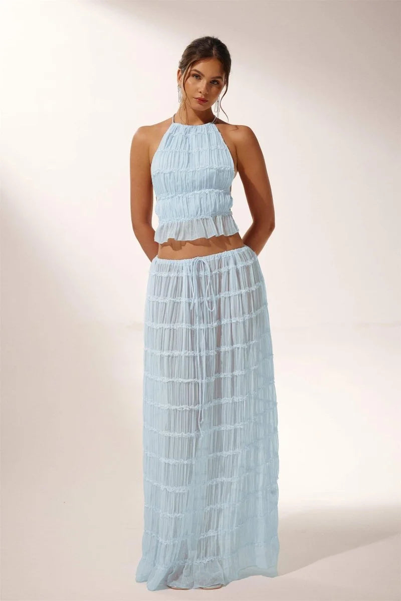 "Light blue pleated halter crop top and skirt set for the Avi collection, featuring a breezy and stylish design."