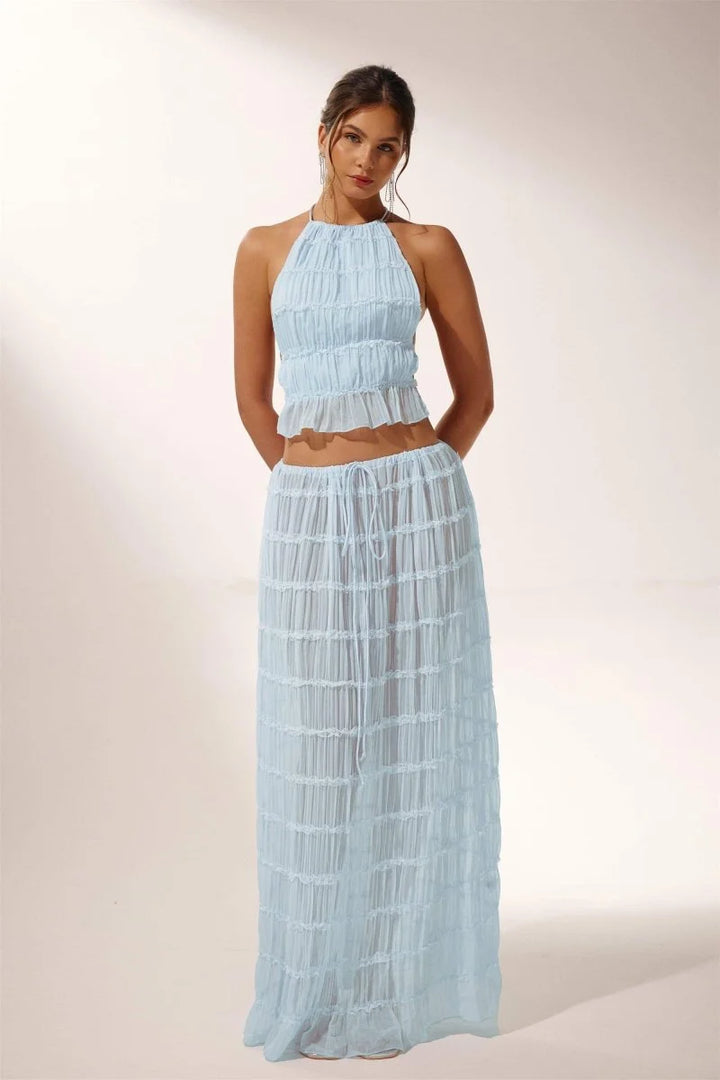 "Light blue pleated halter crop top and skirt set for the Avi collection, featuring a breezy and stylish design."
