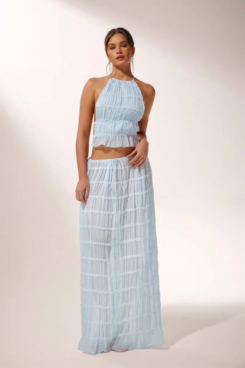 Light blue pleated halter crop top and skirt set. Made with soft and flowy fabric. Perfect for a stylish and chic summer…
