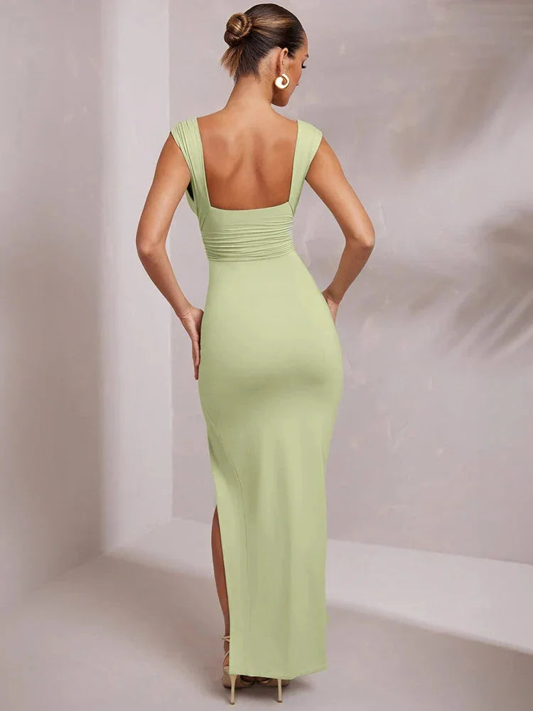 Black midi dress with V-neck, front slit, and figure-hugging silhouette. Made from smooth, lightweight fabric for a sleek…