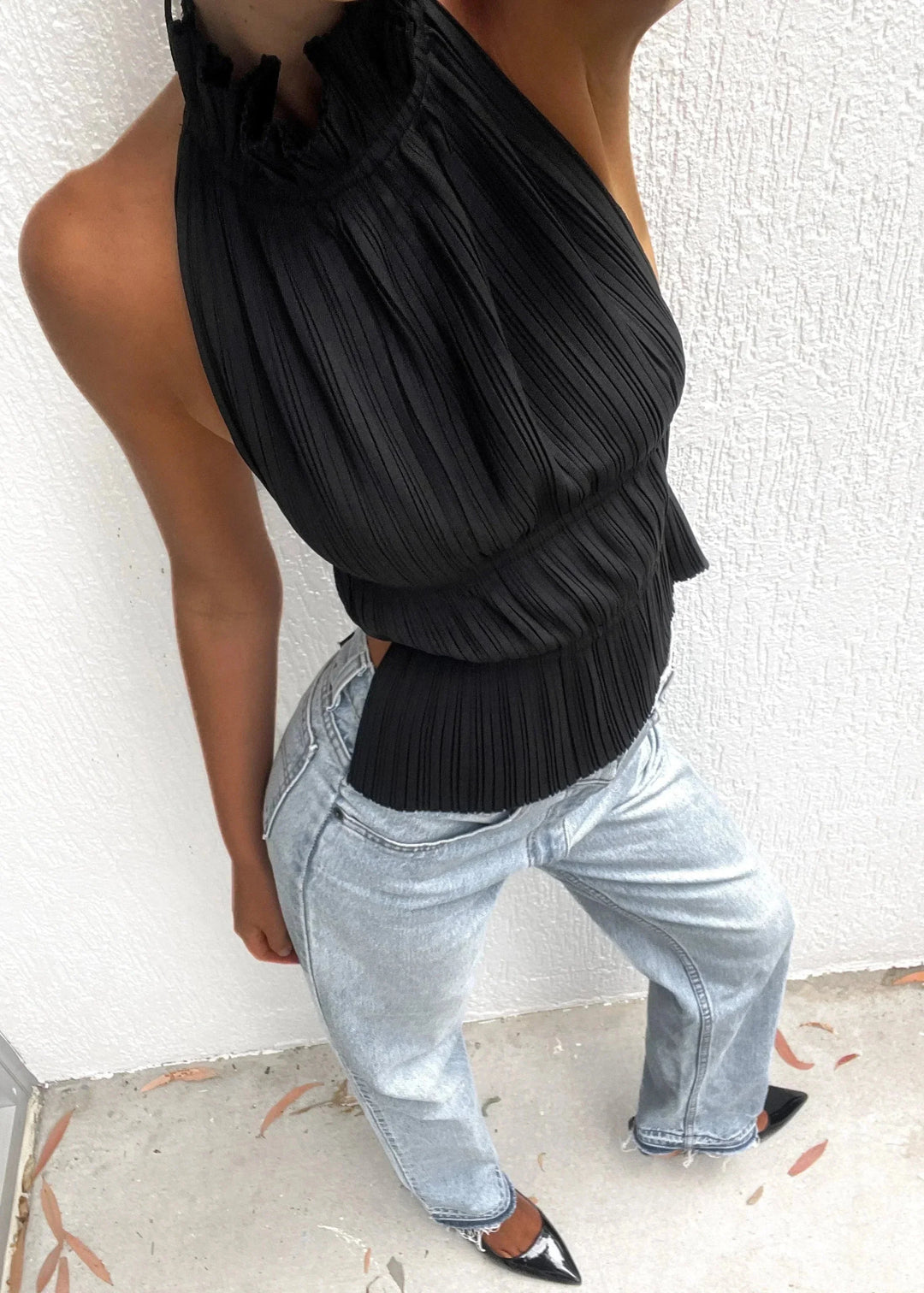 Women's black halter top with metallic chain details, perfect for a chic and trendy outfit.