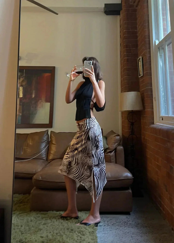 "Women's halter top in black with metallic chain embellishments, perfect for adding edgy style to your look."