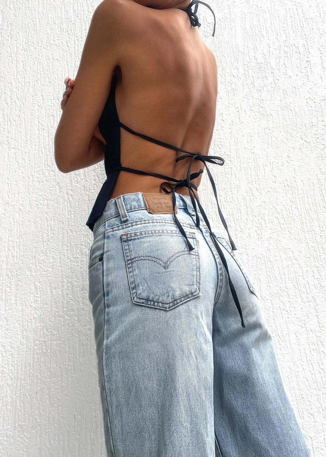 Black halter top showcasing metallic chain detailing and a stylish design by Avonlea for women.