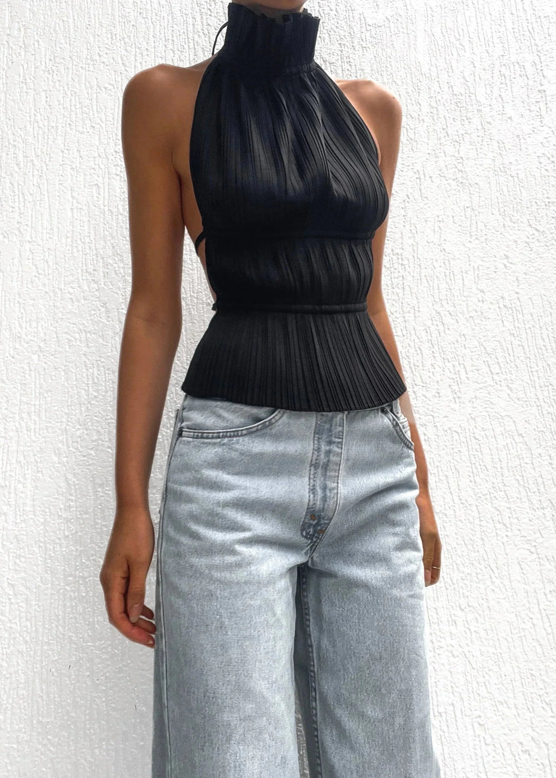 Black halter top with metallic chain accent for women, crafted with high-quality fabric, perfect for casual or evening wear.