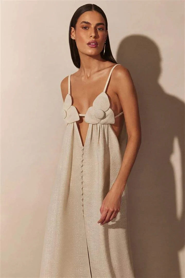 "Beige maxi dress with floral details, slit, and flowy silhouette, perfect for casual or formal occasions."