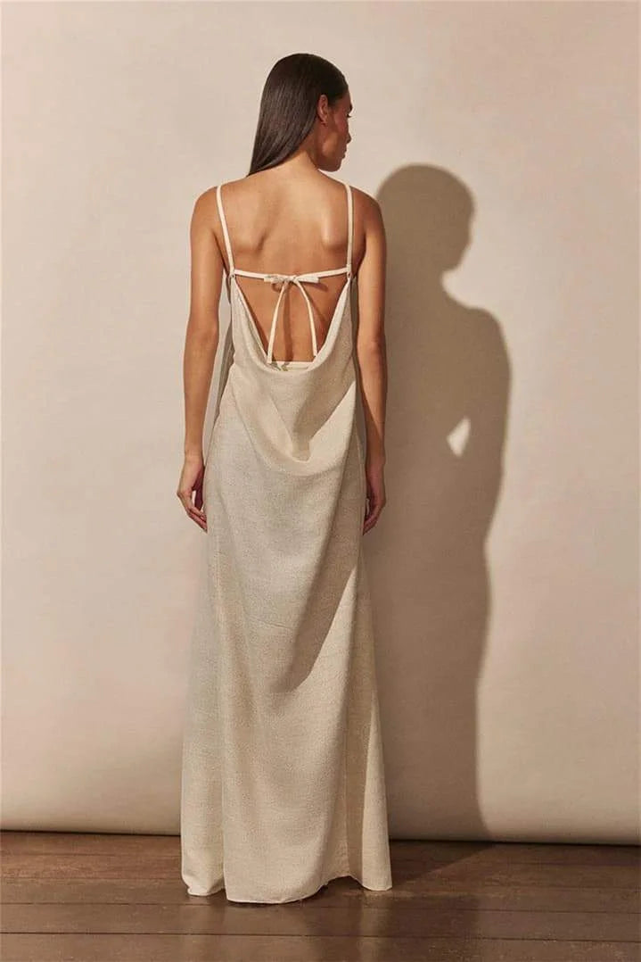 "Beige maxi dress with floral details and slit, made of breathable fabric, perfect for breezy summer days."