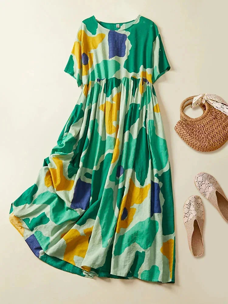 Green short sleeve maxi dress with a unique floral print design, made from comfortable and breathable fabric.