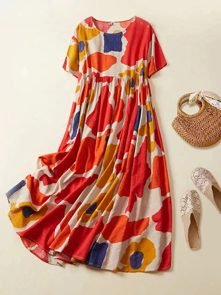 Red short sleeve maxi dress with a colorful printed design, made of lightweight and flowy fabric for a stylish and…