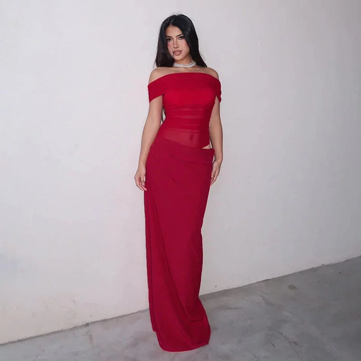 Off-shoulder ruched maxi dress with waist cut-out in soft crepe fabric, perfect for a summer evening out.
