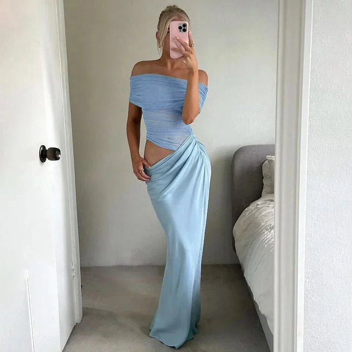 Blue off-shoulder maxi dress with ruched detailing, waist cut-out, and flowing silhouette.