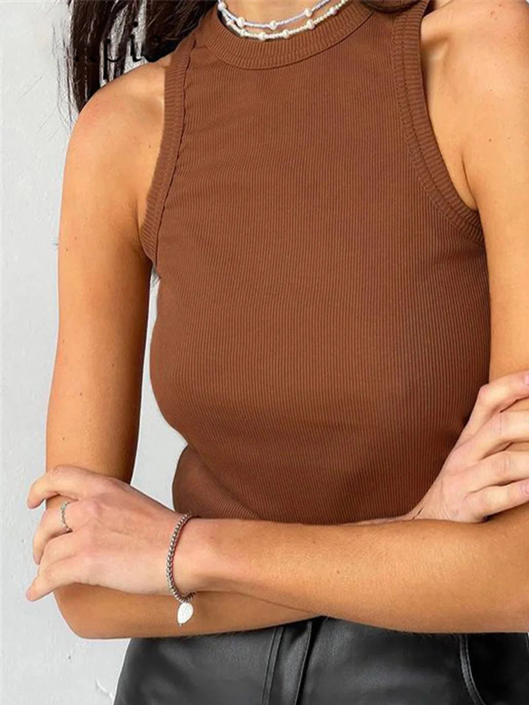 Light brown sleeveless ribbed tank top, versatile for any occasion, made of high-quality material.