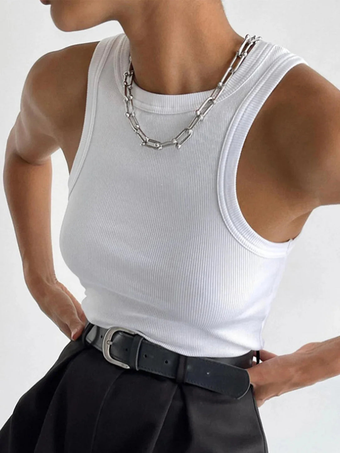 White sleeveless ribbed tank top in a versatile design by Beverly. crafted with soft and stretchy material for all-day…
