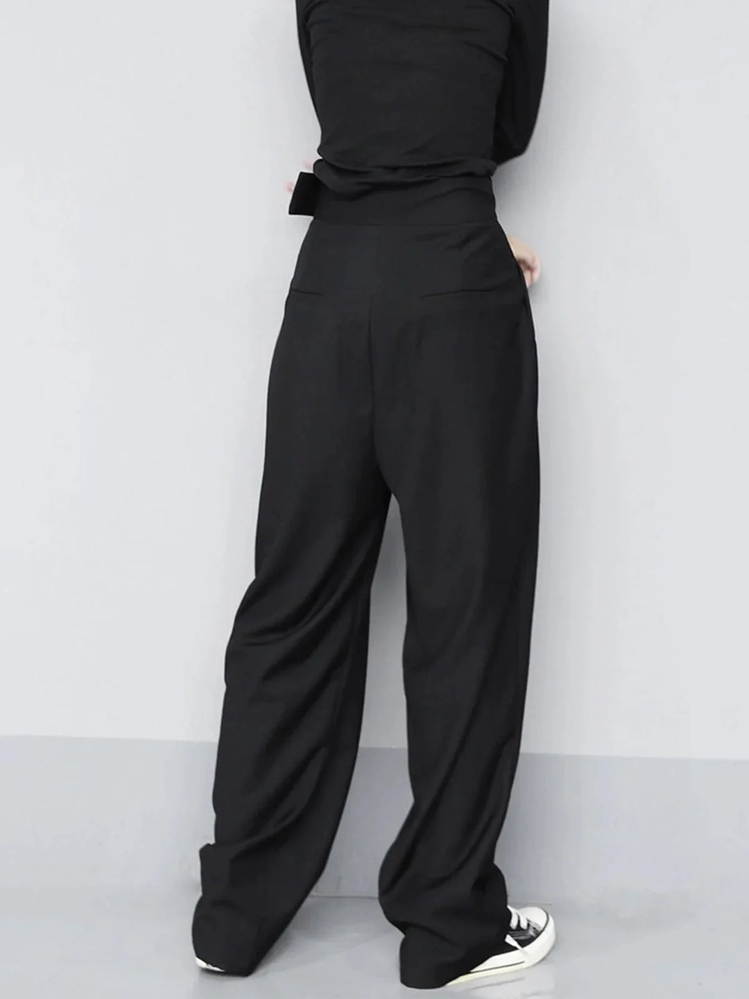 "Beige wide-leg pants with adjustable fit details, ideal for a versatile wardrobe. Made of lightweight, comfortable fabric."