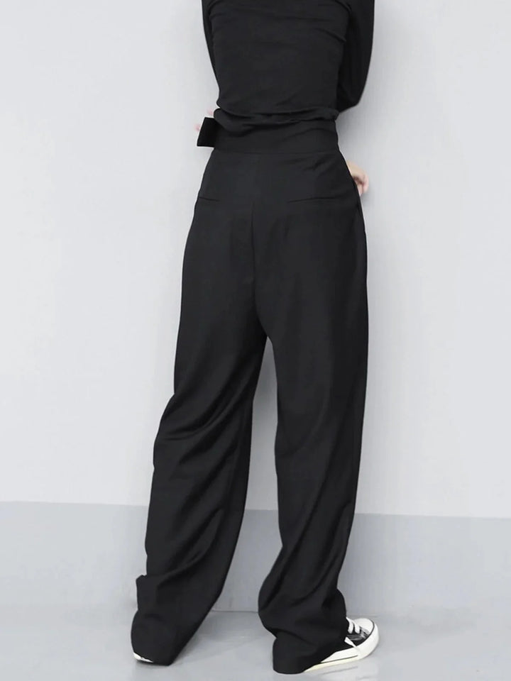 "Beige wide-leg pants with adjustable fit details, ideal for a versatile wardrobe. Made of lightweight, comfortable fabric."