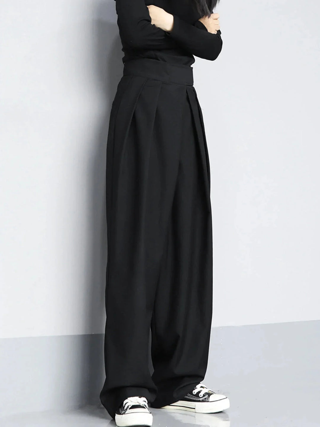 "Black wide-leg pants with adjustable fit, made from comfortable stretch fabric, ideal for casual and office wear."