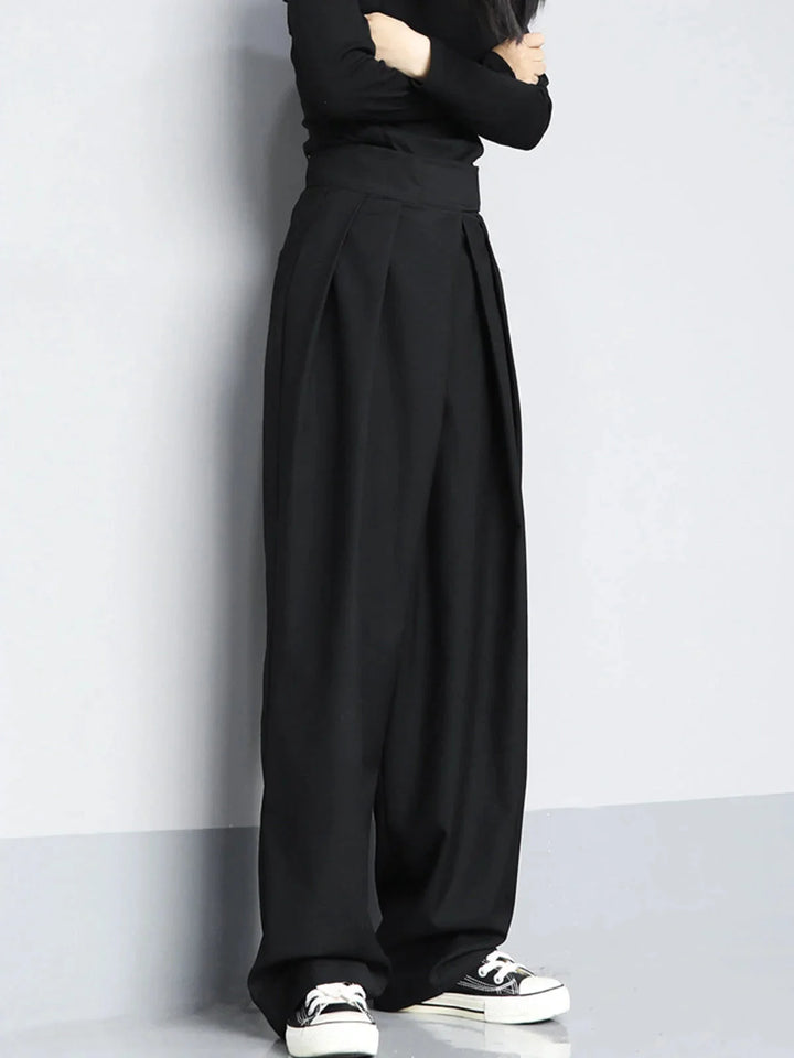 "Black wide-leg pants with adjustable fit, made from comfortable stretch fabric, ideal for casual and office wear."