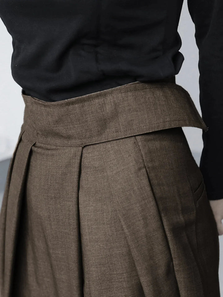 Navy blue wide-leg pants with adjustable waistband and a relaxed fit, made from soft and breathable fabric.