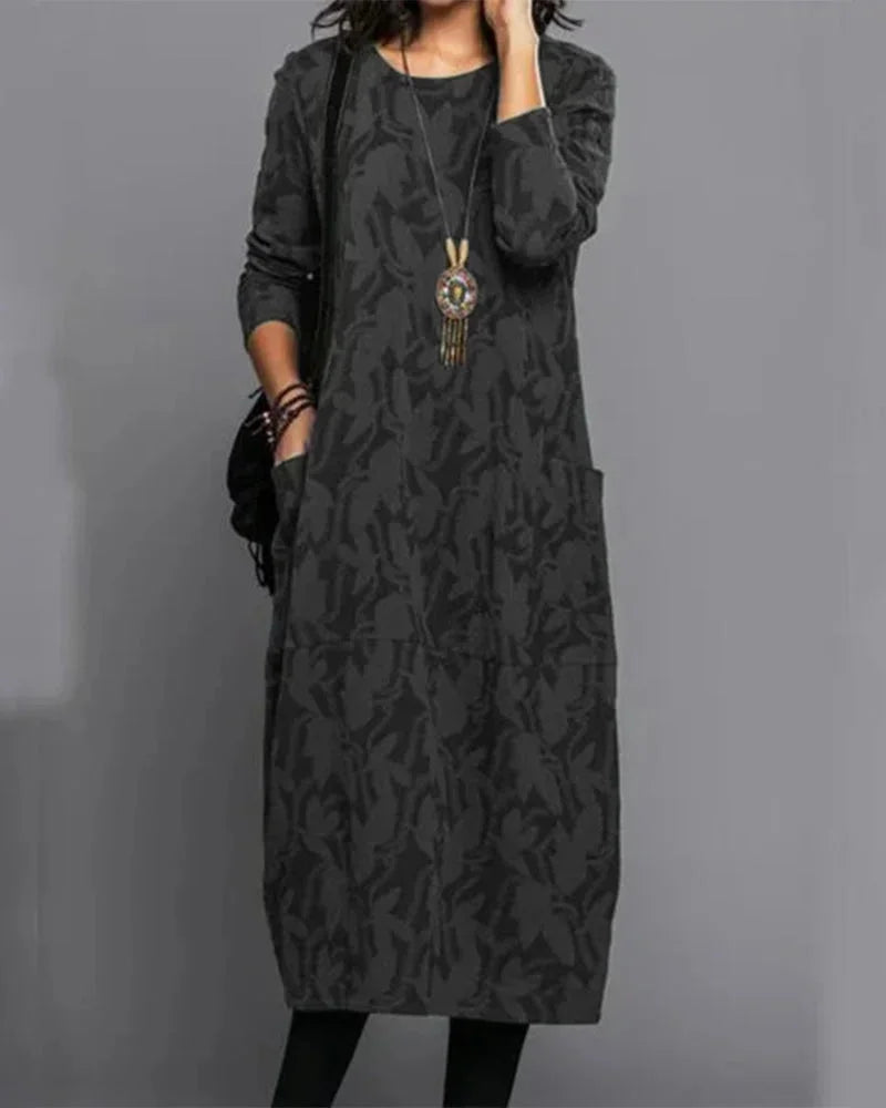 Black midi dress with camo pattern, made from soft and stretchy fabric. Features a comfortable fit perfect for everyday wear.