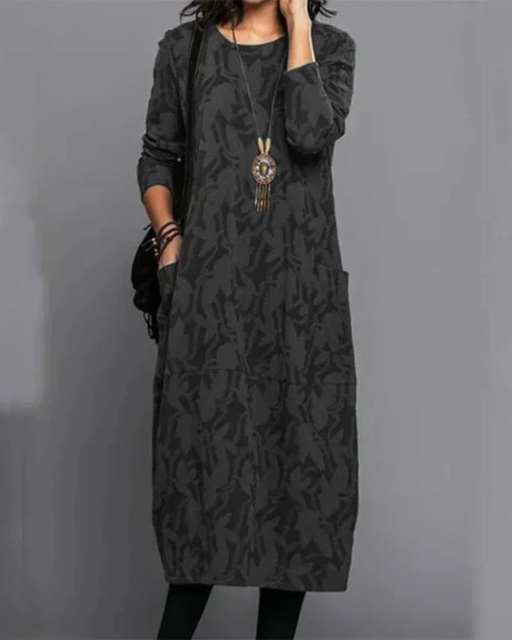 Black midi dress with camo pattern, made from soft and stretchy fabric. Features a comfortable fit perfect for everyday wear.