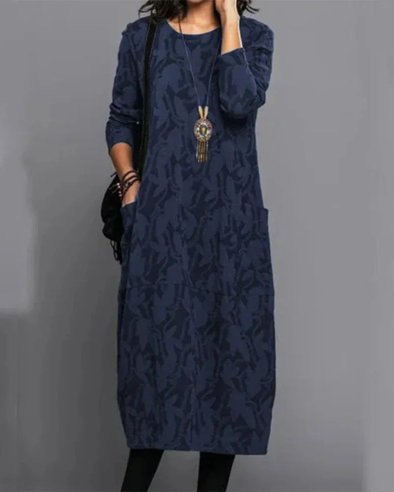 Blue midi dress with camo pattern, made with comfortable material. Perfect for a casual yet stylish look.