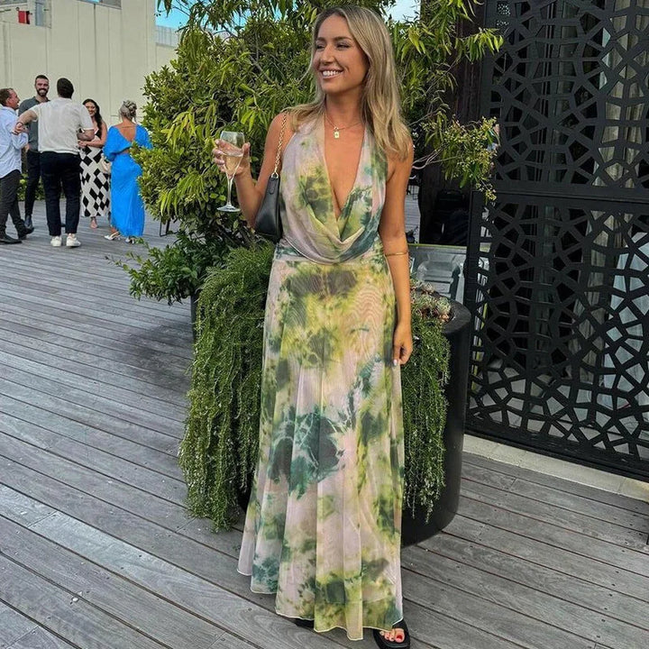 Colorful tie-dye halter dress featuring a backless design, perfect for sunny days.