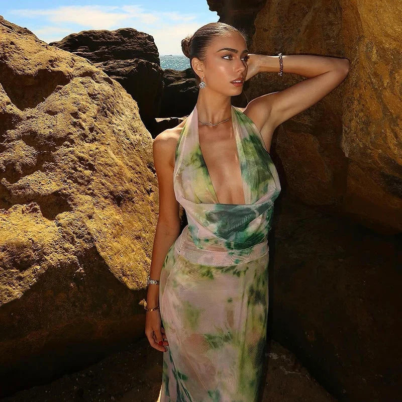 Boho-chic tie-dye halter dress with a stylish backless design, perfect for summertime.