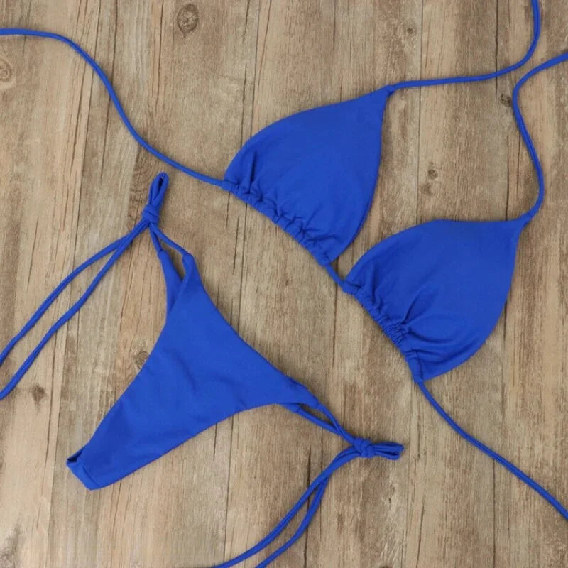 Black halter neck bikini with adjustable ties for a comfortable fit, made from a soft and stretchy fabric.
