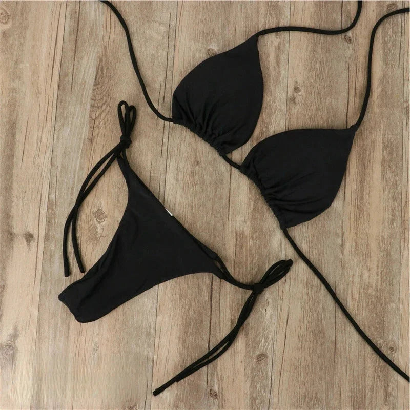 Black halter neck bikini with adjustable ties, perfect for beach days. Made with comfortable and stretchy fabric for a…