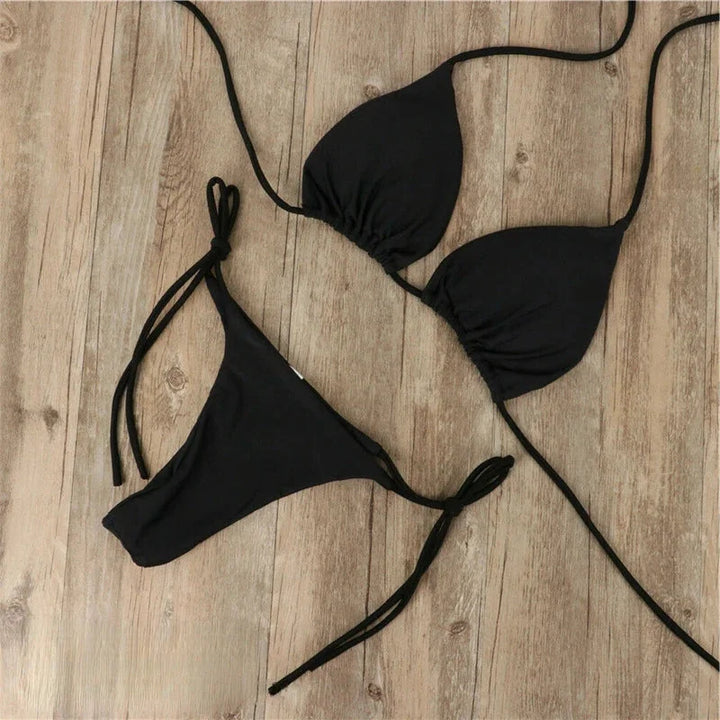 Black halter neck bikini with adjustable ties, perfect for beach days. Made with comfortable and stretchy fabric for a…