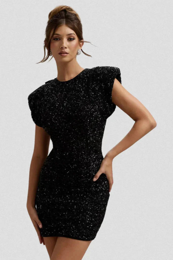 "Gray fitted dress with sparkly detailing, featuring shoulder pads. Perfect for a glamorous night out."