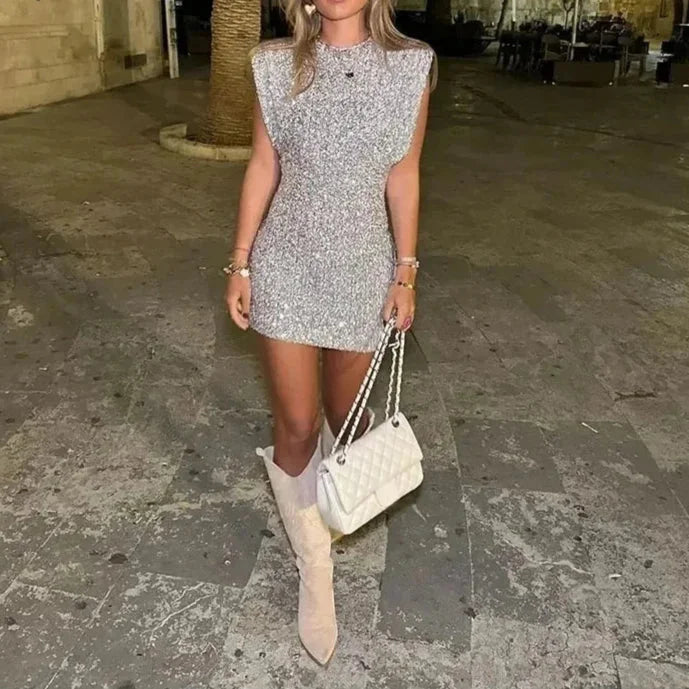Silver sequin fitted dress with padded shoulders and V-neck, perfect for a glamorous night out or special occasion.
