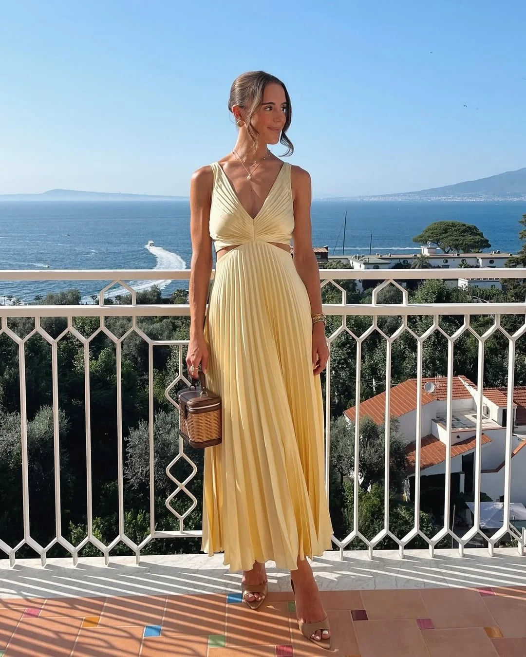 Yellow pleated maxi dress with plunging neckline, perfect for a special occasion. Made with flowing and breathable fabric…