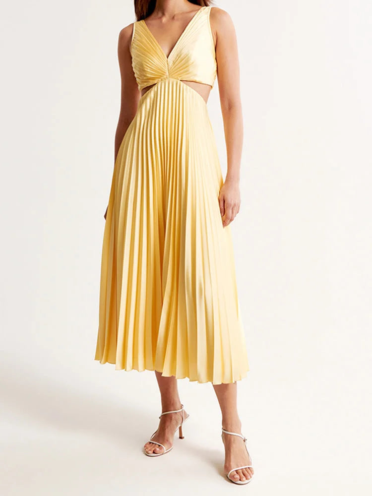 Yellow pleated maxi dress with plunging neckline, perfect for sunny days. Made from soft, flowy fabric with elegant pleats.