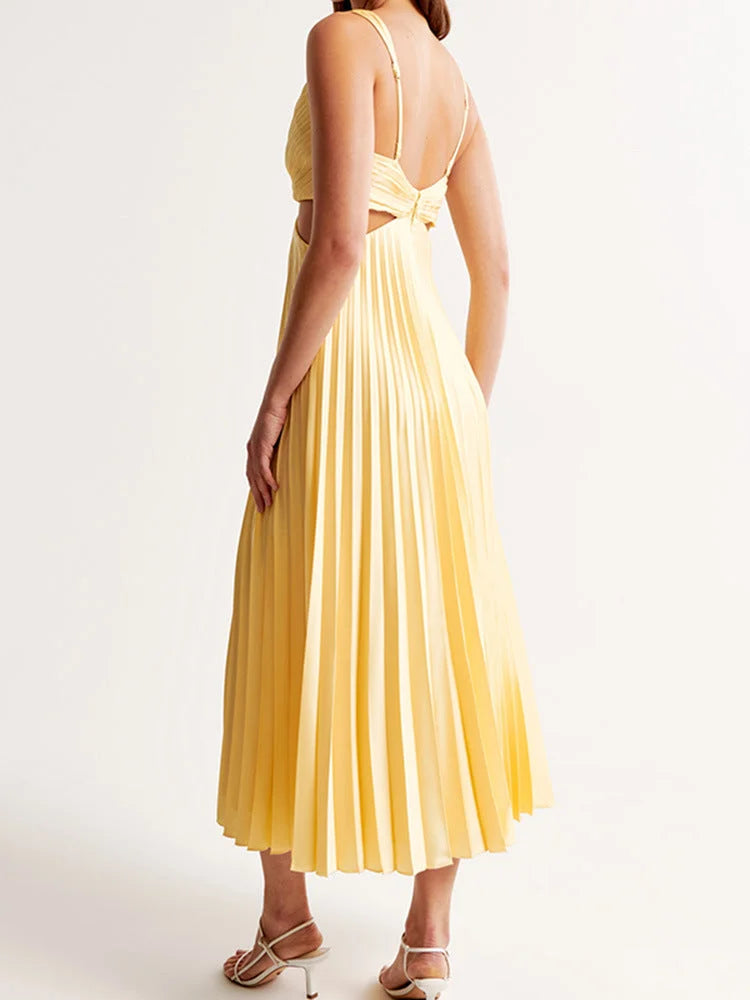 Yellow pleated maxi dress with plunging neckline. Flowy and elegant. Made of soft, airy fabric. Perfect for a sunny day out.