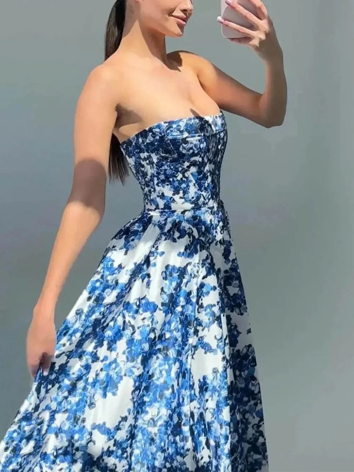 Strapless blue floral printed maxi dress featuring soft and flowy fabric with a bold and vibrant floral pattern.