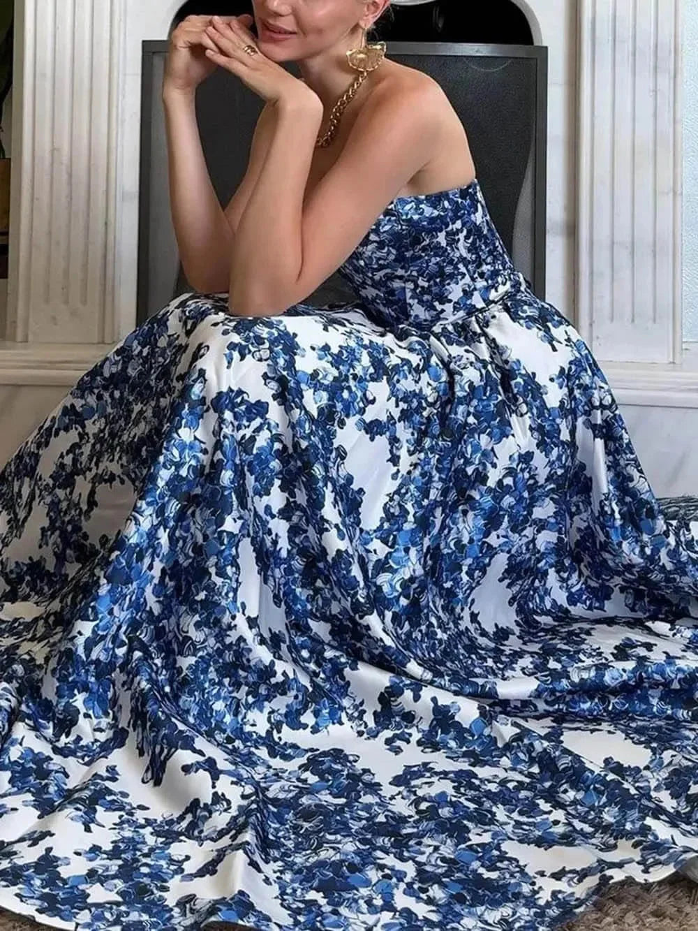 "Blue strapless maxi dress with vibrant floral print, perfect for warm seasons and casual occasions."