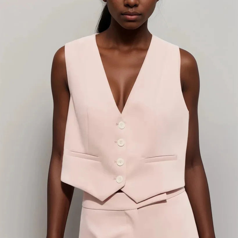 Soft pink V-neck vest featuring button details, a must-have for your wardrobe.