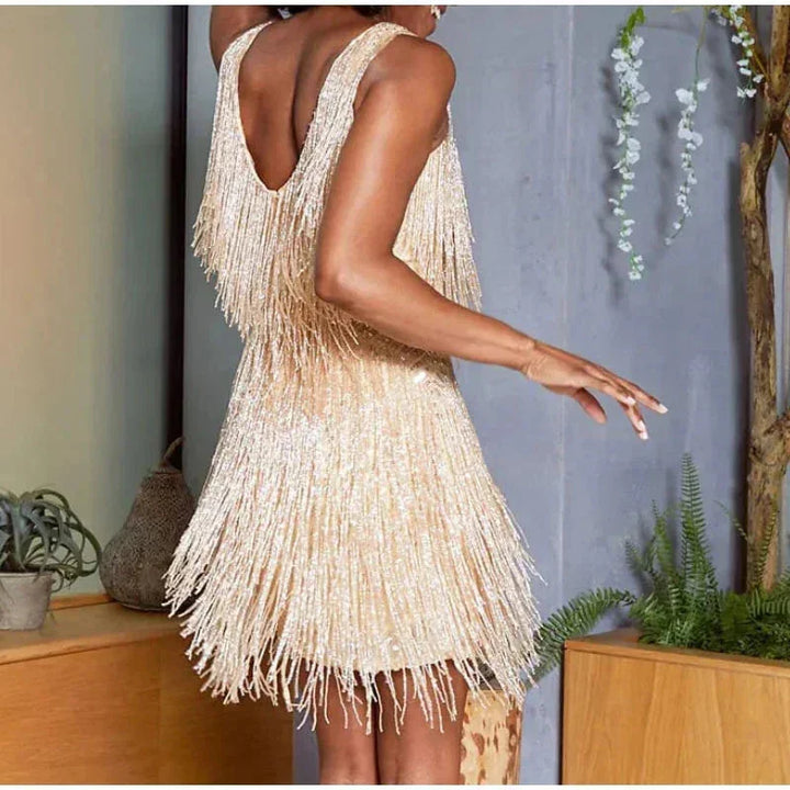 Black mini dress adorned with sequins and feathers, featuring spaghetti straps.