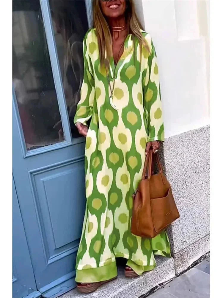 Green long-sleeve V-neck maxi dress made from flowing fabric with a bohemian-inspired design.