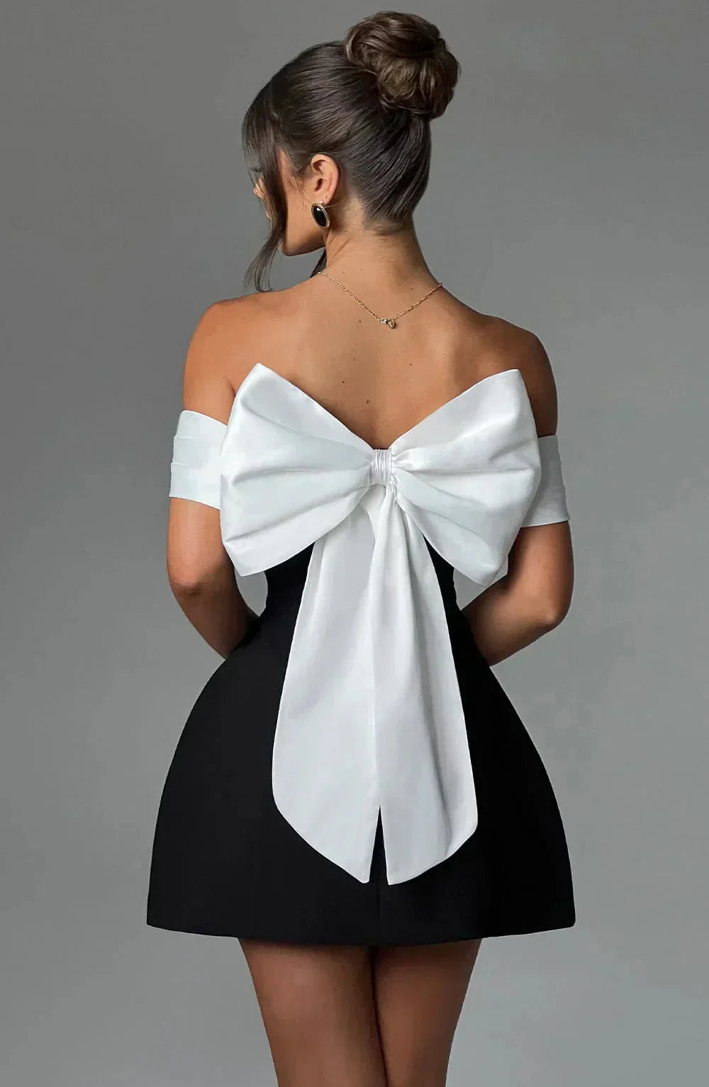 Off-shoulder mini dress in two-tone design with a flowing silhouette and elasticized neckline by Carmela.